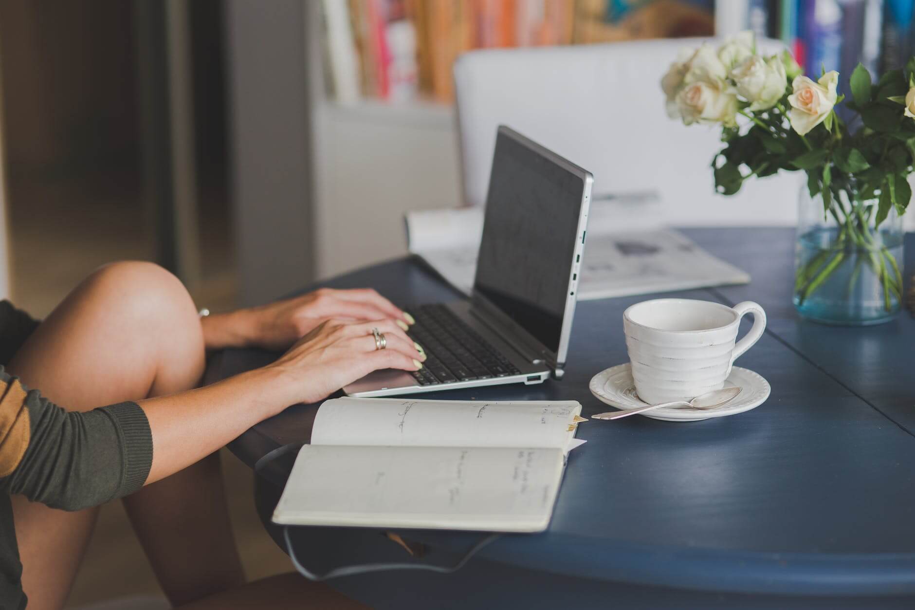 Woman Typing Having Coffee