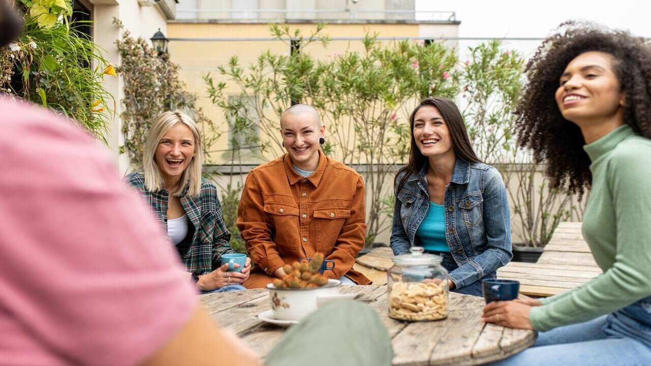 Group of friends chatting about the benefits about a career change after 40